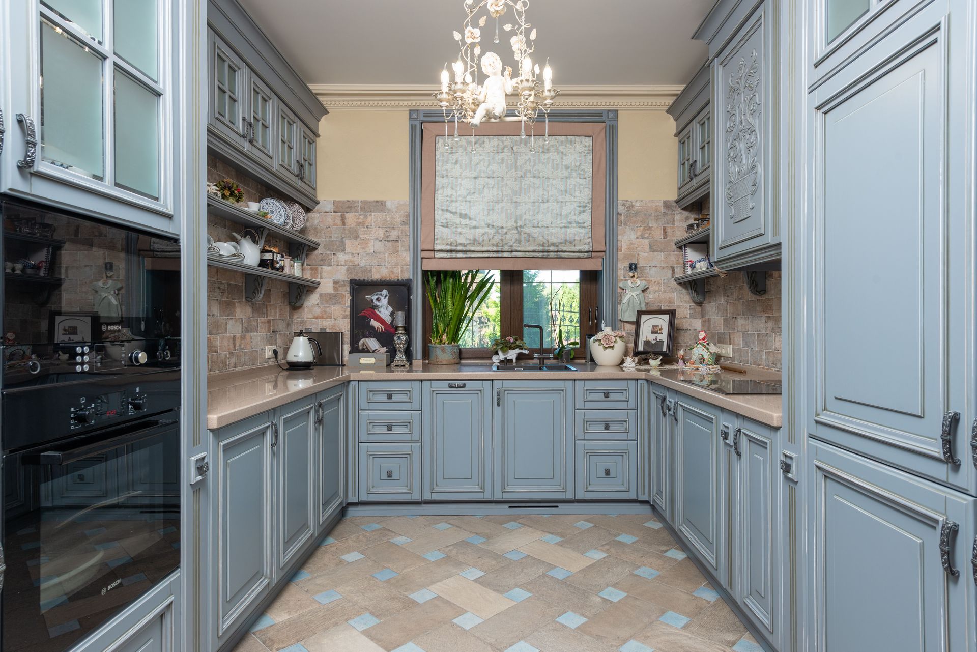 Discover an elegant vintage-style kitchen with classic cabinets and ornate chandelier.